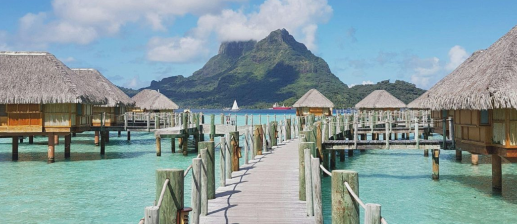 St Regis Maldives Vommuli overwater villas in clear blue lagoon